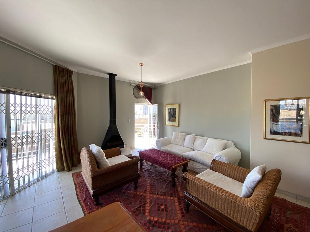 Open-plan kitchen, lounge and dining area with fireplace