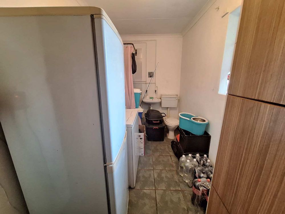 Storage room with shower and toilet