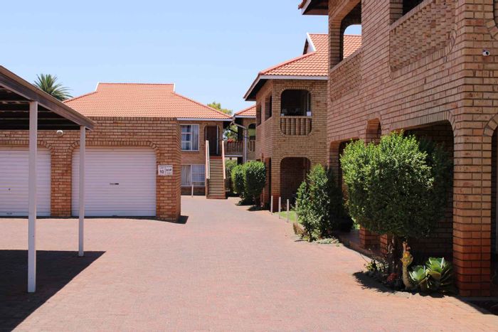 Townhouse for Sale in Alberton Central: Pool, braai area, two bedrooms, open-plan living.