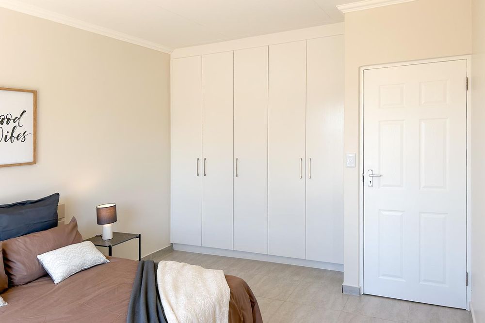 Main bedroom with built-in cupboards and ensuite bathroom.