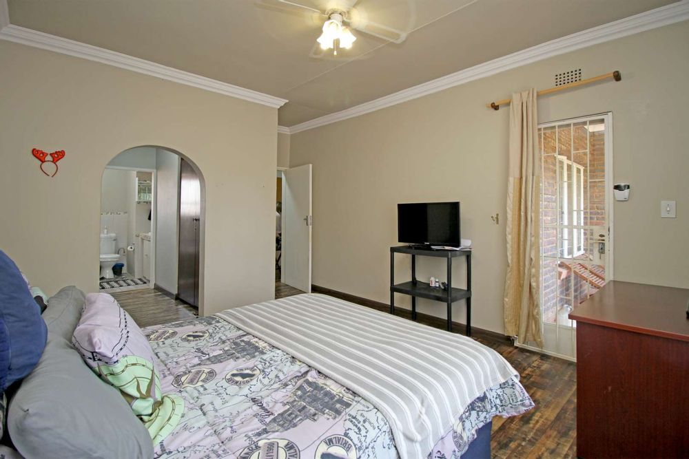MAIN ENSUITE BEDROOM AND BATHROOM WITH HIS AND HERS BUILT-IN CUPBOARDS IN A SEPARATE DRESSING AREA