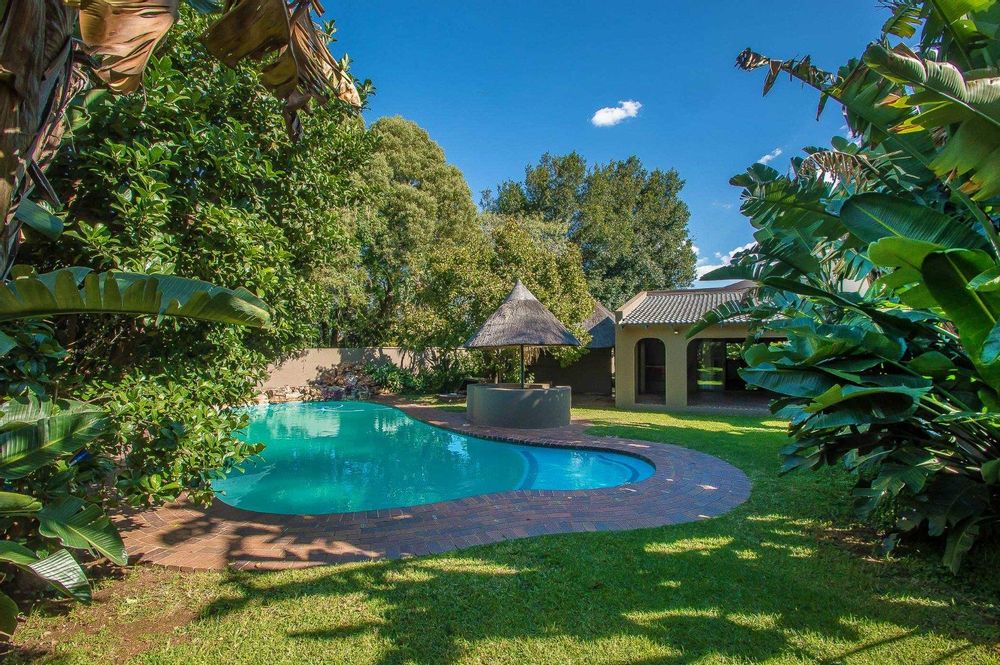 Exquisite entertainment area includes pool, braai area, covered patio jucuzzi and more