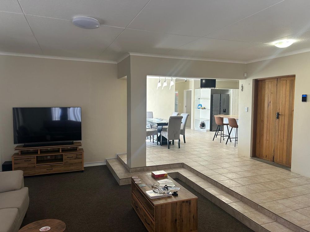 Tv room connecting directly to the kitchen and dining area