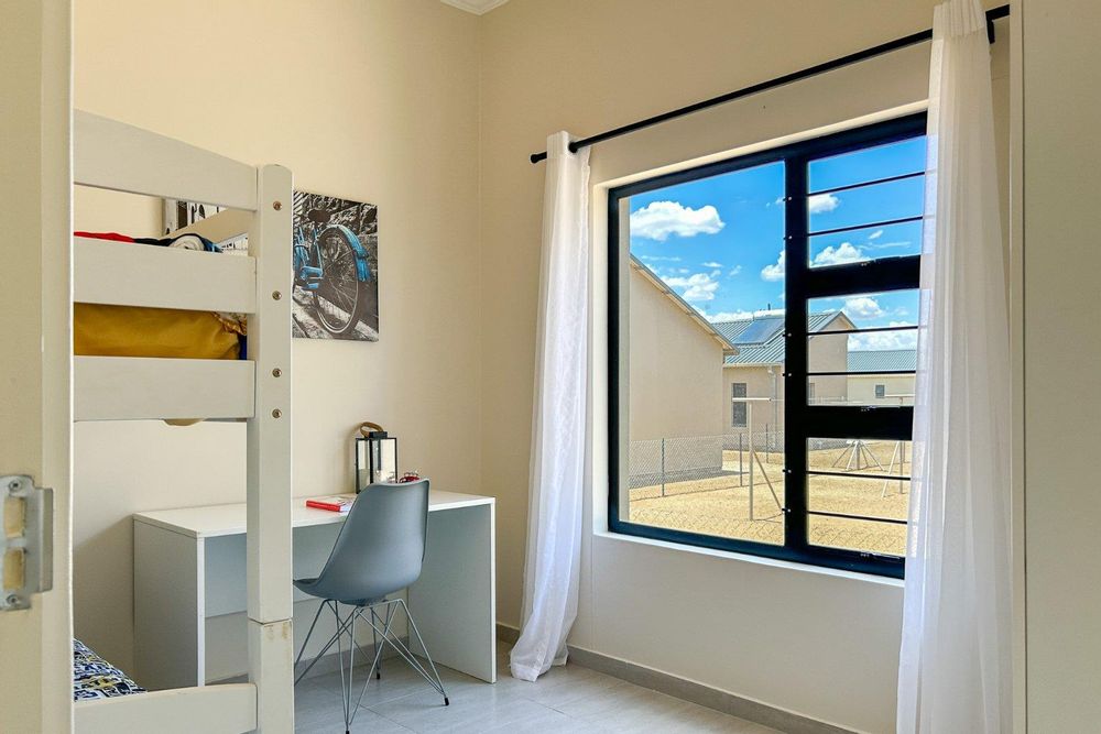 Second bedroom with built-in cupboards.