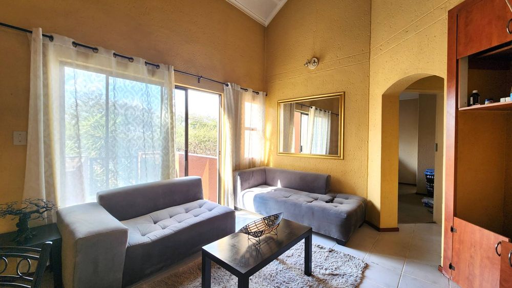 Lounge with sliding door onto the downstairs patio.