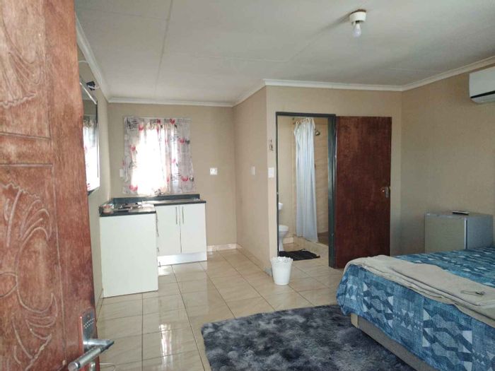 For Sale: House in Mabopane with five bachelor rooms, parking, and caretaker unit.