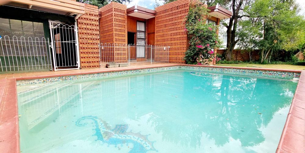 Sparkling pool next to undercover entertainment area