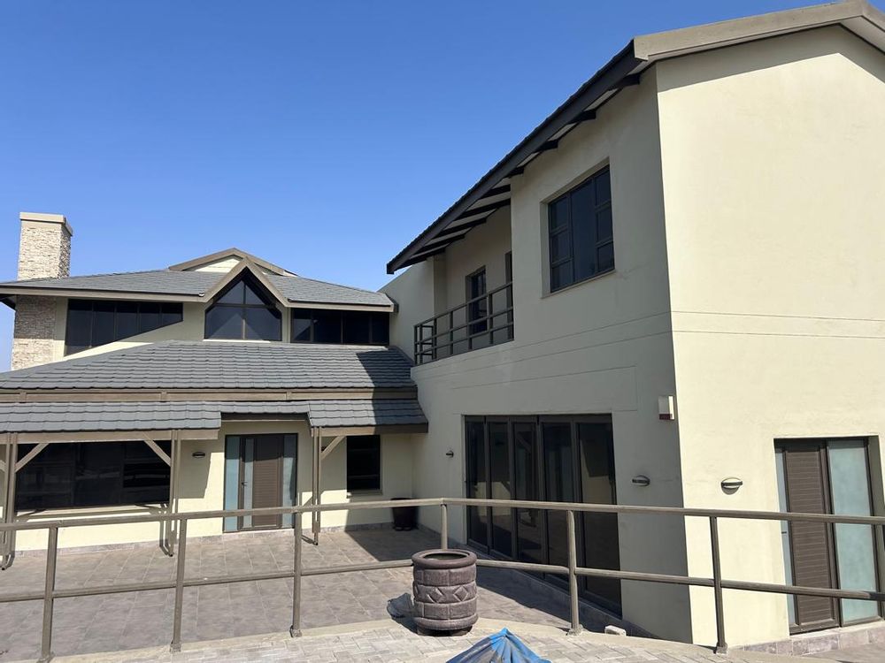 A very sunny front yard with swimming pool