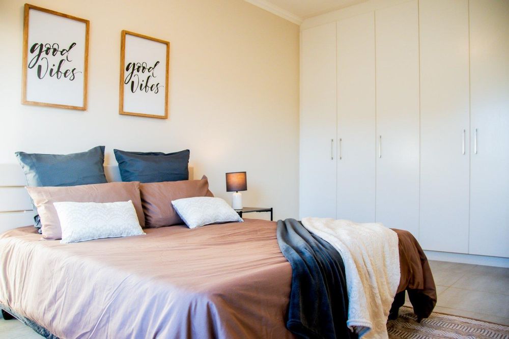 Main bedroom with built-in cupboards and ensuite bathroom.