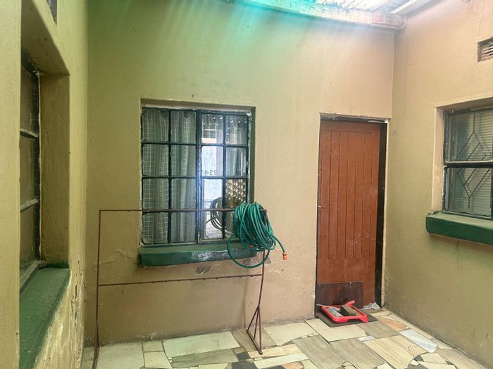 For Sale: House in Tembisa Central with 4 income-generating flatlets and secure yard.