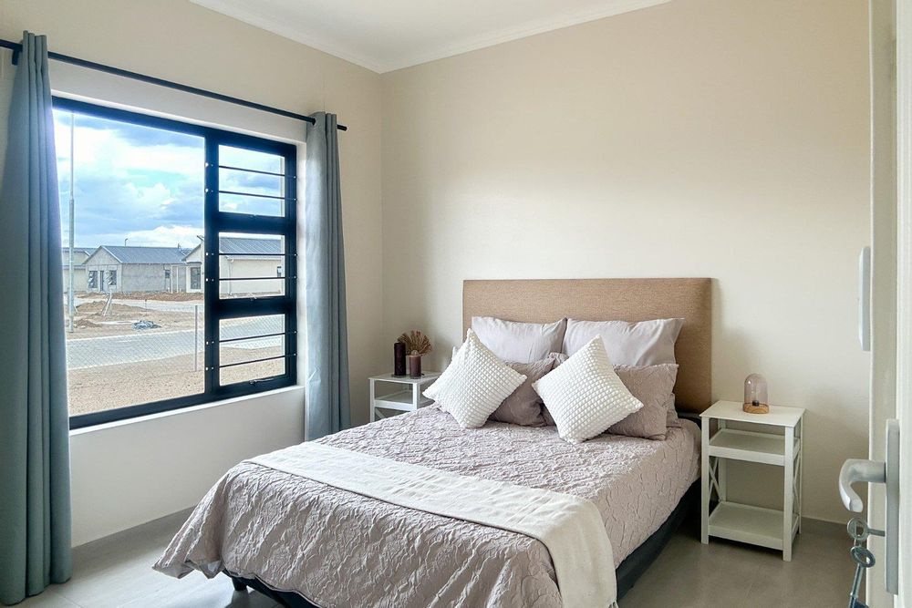 Second bedroom with built-in cupboards.