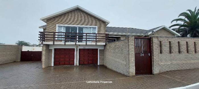 For Sale: Hage Heights House with spacious yard, garages, and entertainment area.