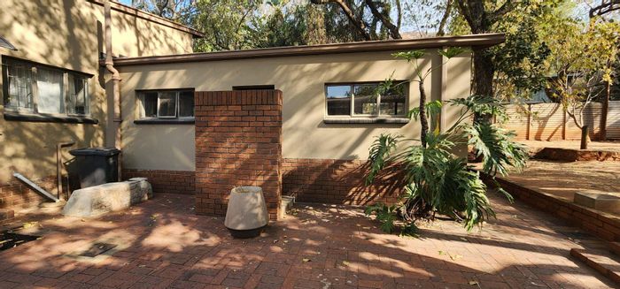 Spacious Pretoria North house with 4 bedrooms, garages, and large yard for sale.