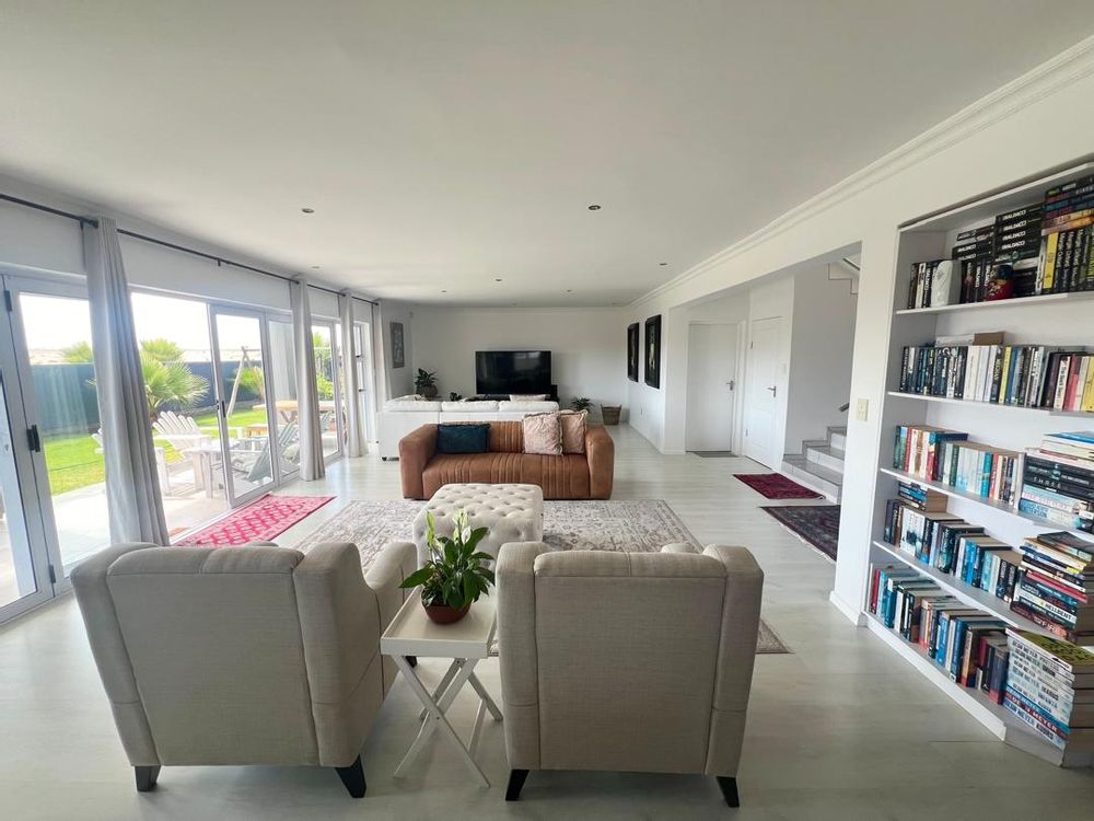 View of the open-plan lounge, French doors, stairs and door leading to ground floor bedroom