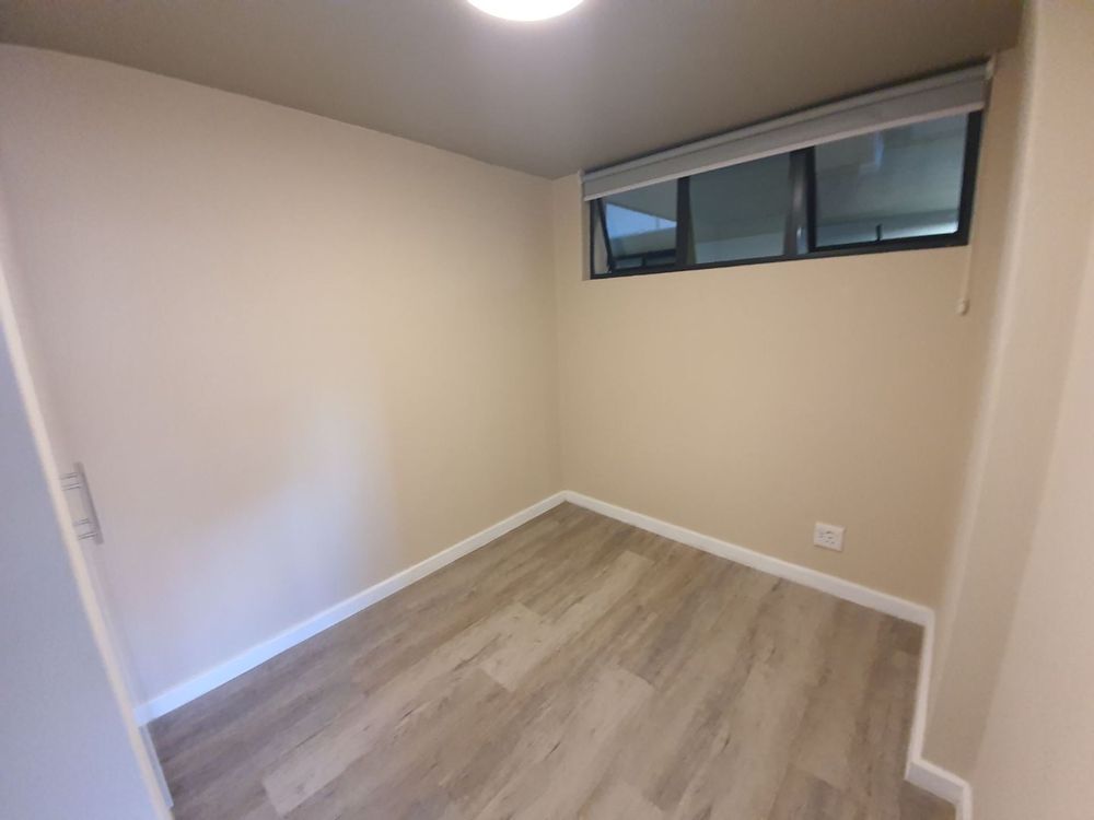 Second bedroom with built-in cupboards.