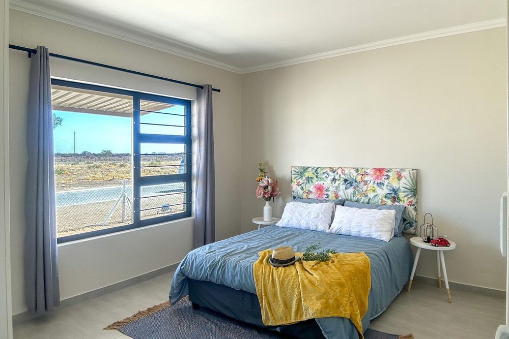 Spacious main bedroom with built-in cupboards.