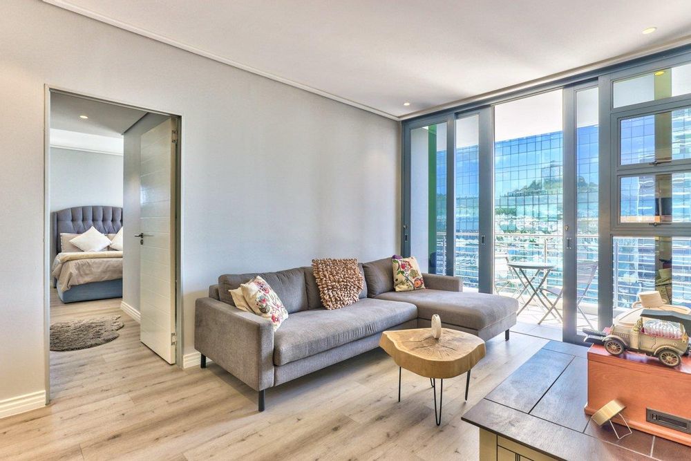 open plan living area opens unto balcony with sea & city views