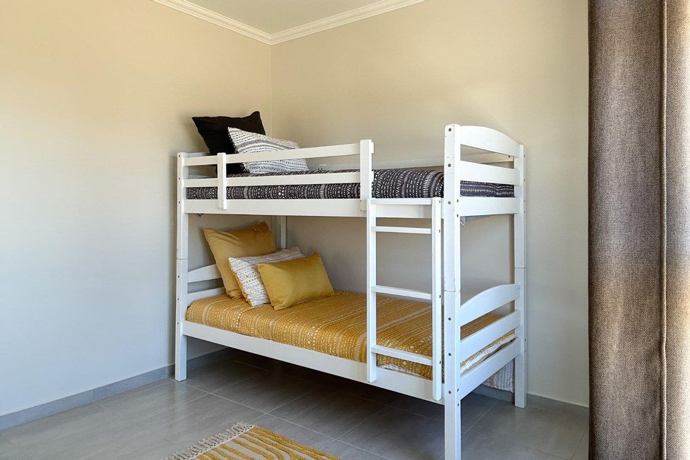 Second bedroom with built-in cupboards.