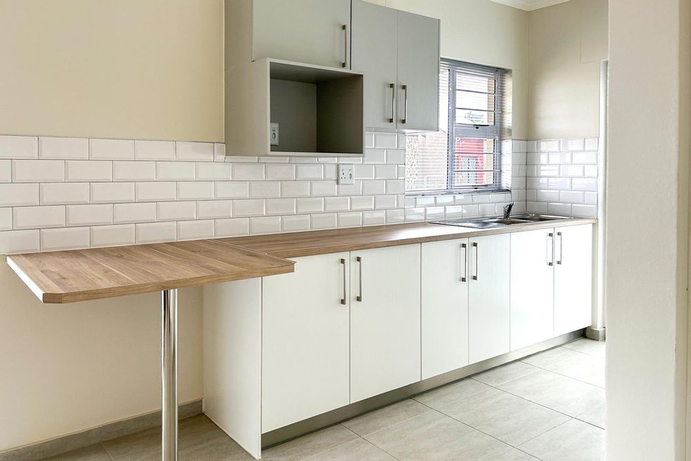 Modern kitchen with built-in cupboards and built-in oven.