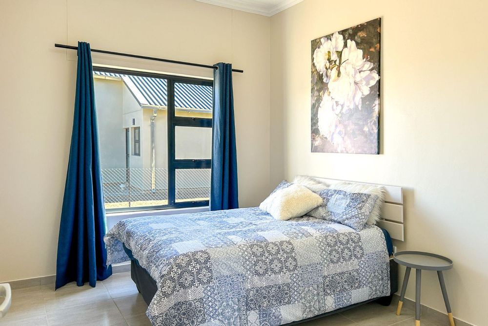 Second bedroom with built-in cupboards.