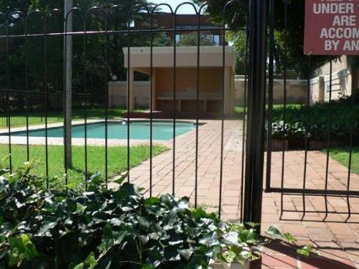 To Rent: Sandown Apartment with pool, security, balcony, and carport.