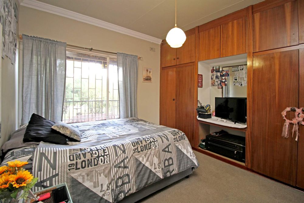 BEDROOM NO. 1 WITH BUILT-IN CUPBOARDS AND VANITY