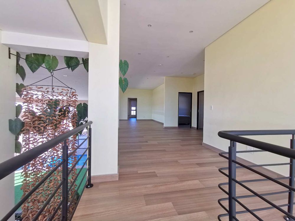 TOP FLOOR LOOKING DOWN TO THE INDOOR GARDEN WITH POOL 
