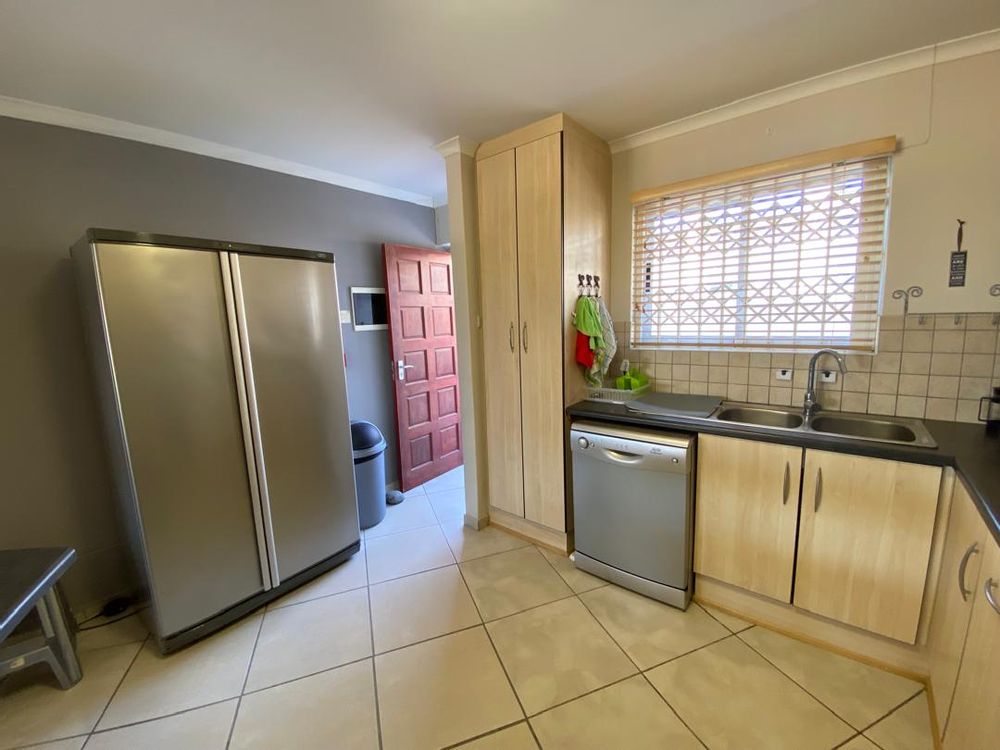 Open-plan kitchen with BIC and front door entrance
