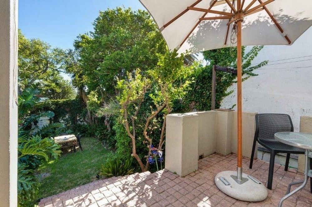 Sunny outdoor patio overlooking private garden 