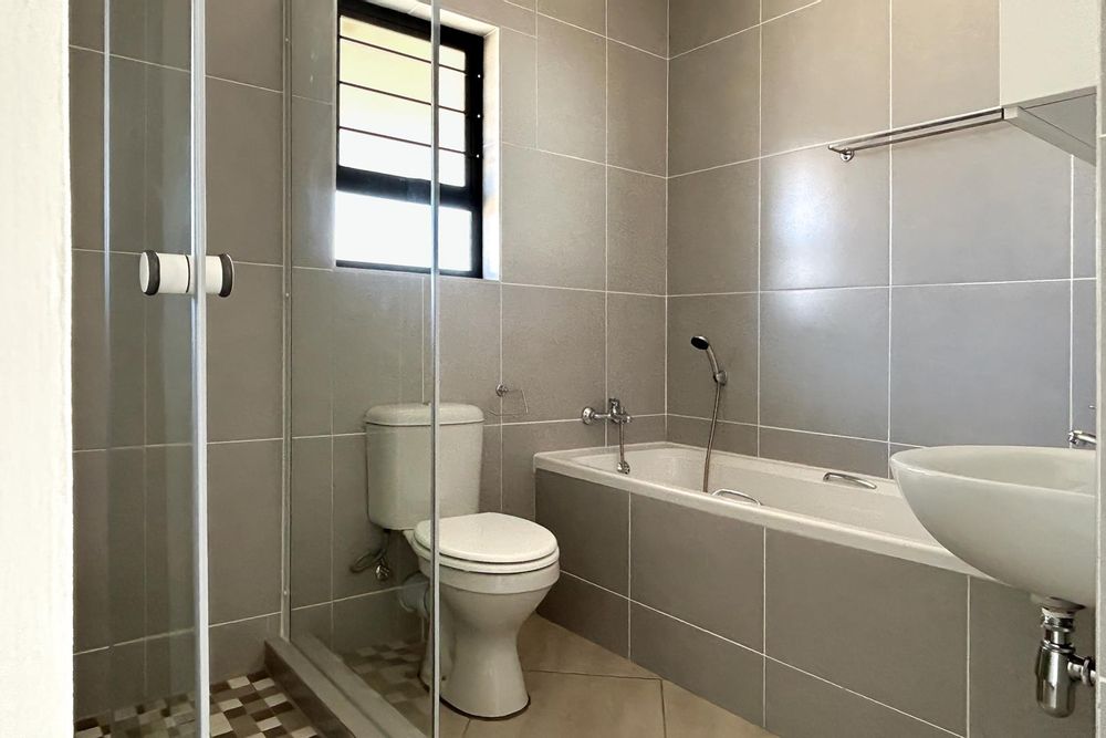 Family bathroom with bath and shower.
