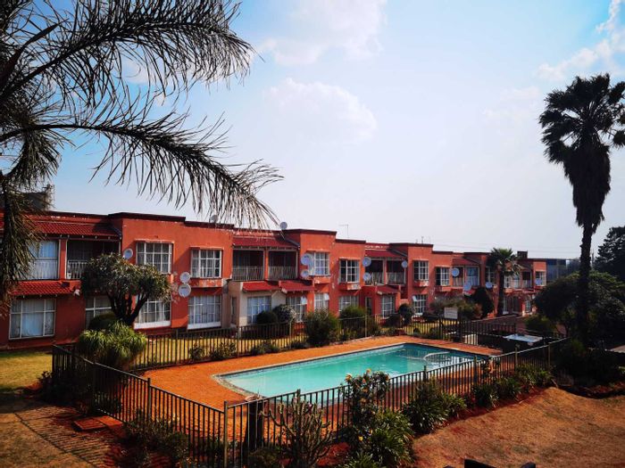 Bright Roodepoort Central apartment with pool, balcony, and secure parking - To Rent.