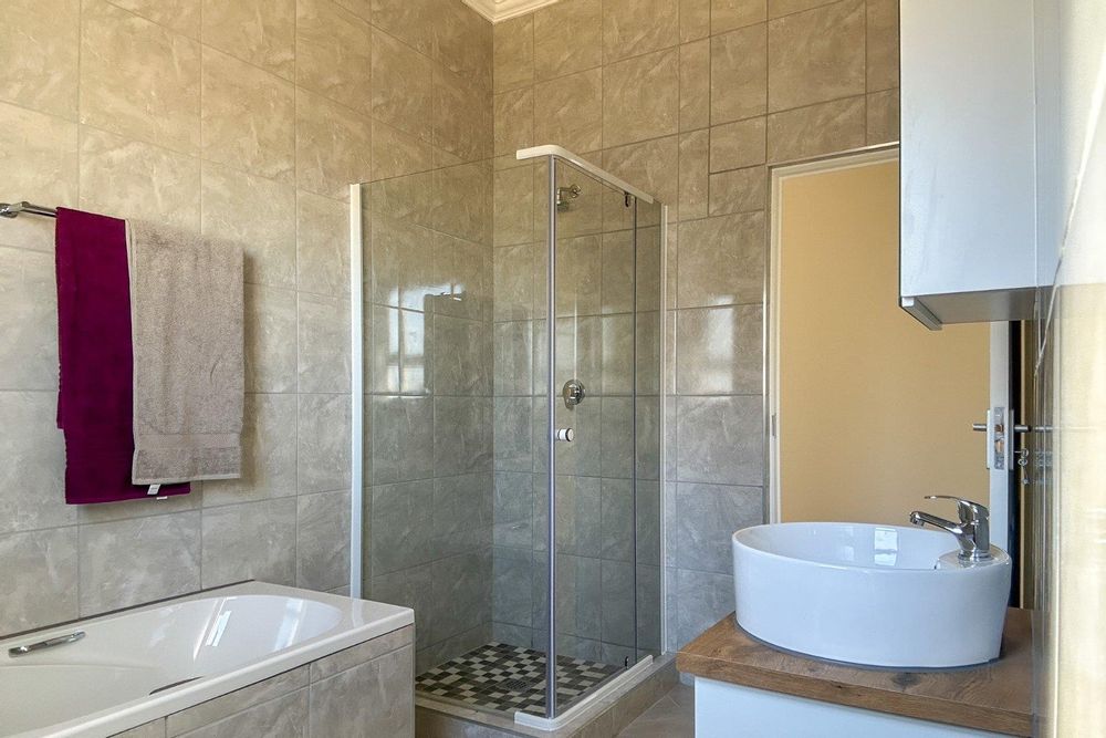 Family bathroom with bath and shower.