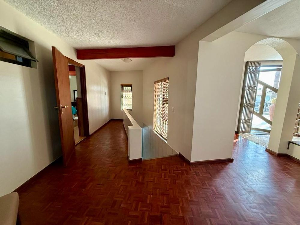 Hallway leading to the two en-suite bedrooms as well as stairs leading to garage downstairs