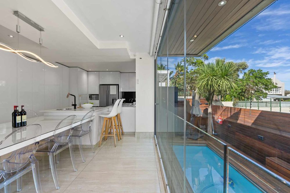Kitchen, dining and stacking doors open on to the pool