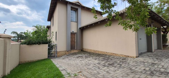 Townhouse To Rent in Ruimsig Country Estate with pool, garden, and security access.