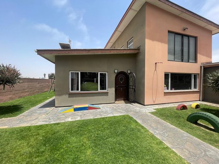 Spacious Lagoon house with flat, BBQ areas, and ample garage space for sale.