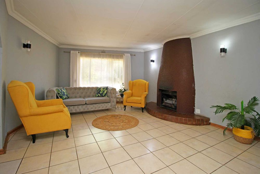 This Open Plan Formal Lounge is a separate designated area that are spacious and inviting for entertaining guests in a sophsticated setting.  The fireplace and chimney creates a very attractive and cosy lounge area.  It is a quiter space located at the front of the house which serves as a buffer between the home's private areas and your guests. It is also the ideal hideaway to have an intimate afternoon reading a book. 