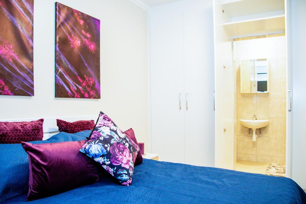 Main bedroom with built-in cupboards and ensuite bathroom.