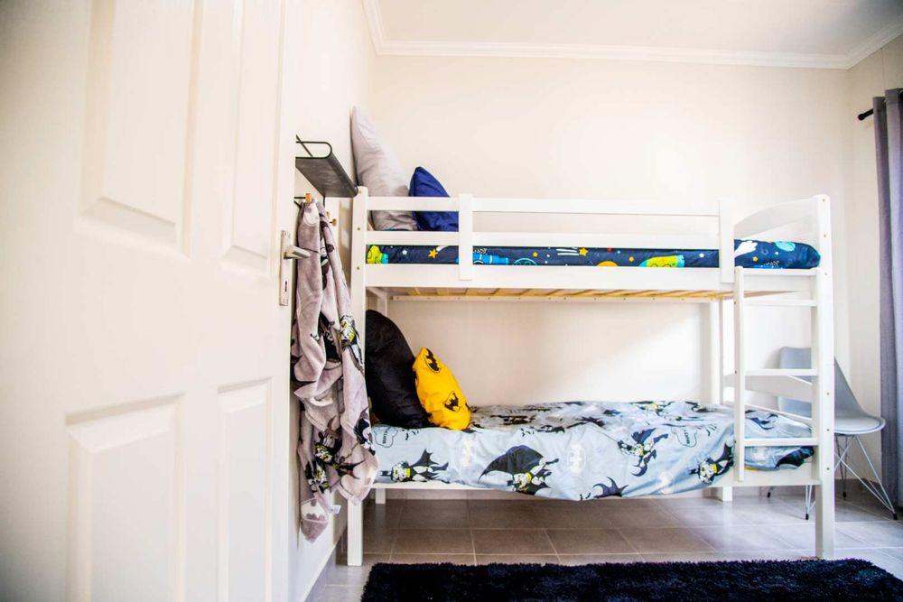 Second bedroom with built-in cupboards.
