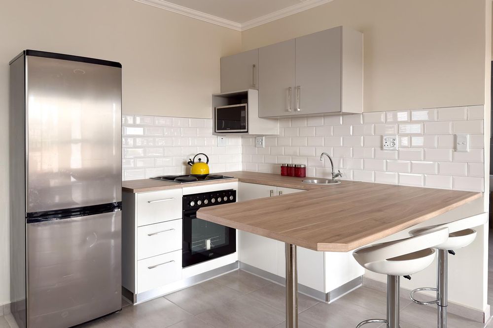 Modern kitchen with plenty of cupboards and separate, kitchen scullery.