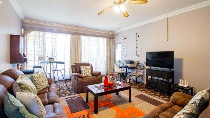 Spacious two-bedroom apartment in Benoni Central, with sunroom and lock-up garage. For Sale.