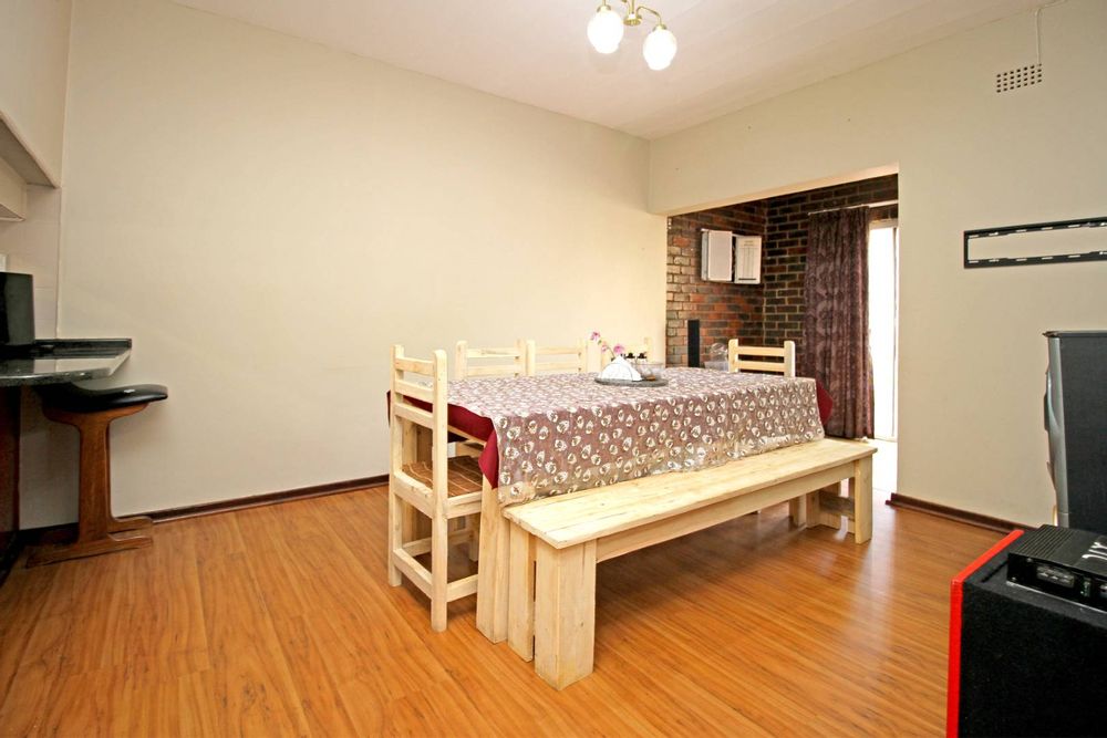 DINING ROOM WITH BREAKFAST NOOK AND THE KITCHEN HATCH AND AT THE BACK OF DINING IS A SLIDING DOOR UNTO THE GARDEN TERRACE