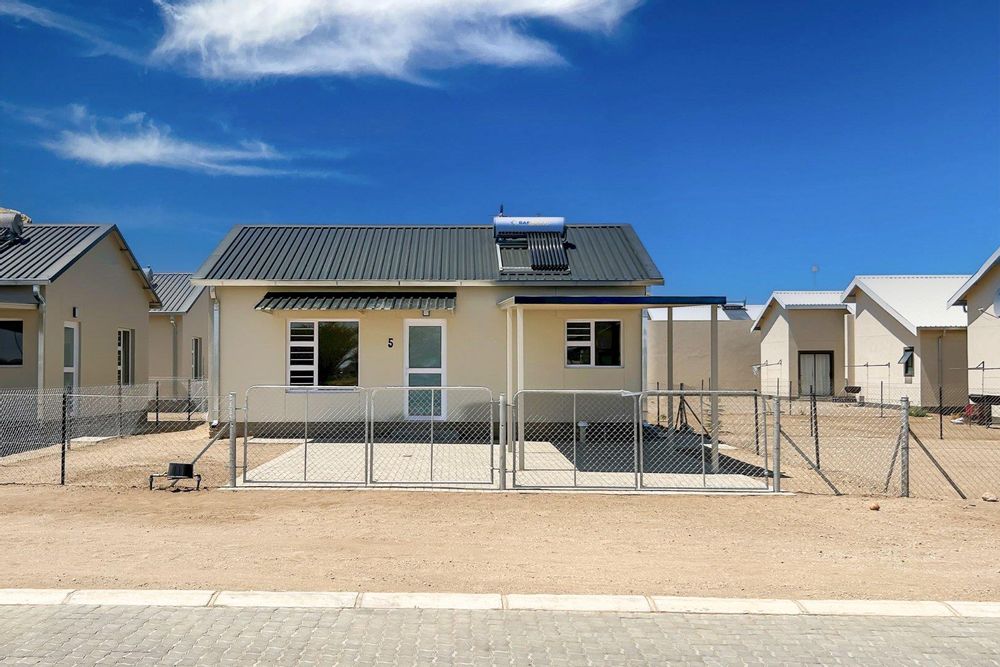 Freestanding townhouse with provision for future expansion and carport.