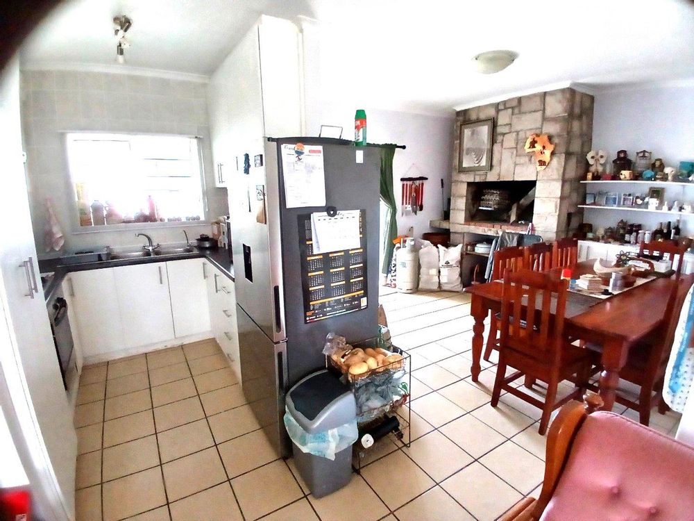 Kitchen on our left - and BBQ Room at the back (the latter accessing Backyard via sliding door).