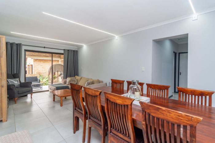 For Sale: Spacious Ruimsig townhouse with garden, double garage, and communal amenities.