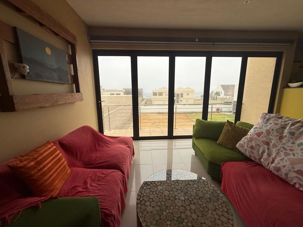 Lounge with a balcony overlooking the ocean at a far distance