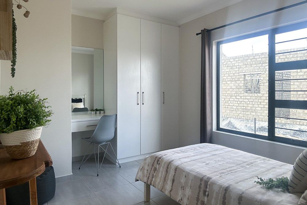 Second bedroom with built-in cupboards.