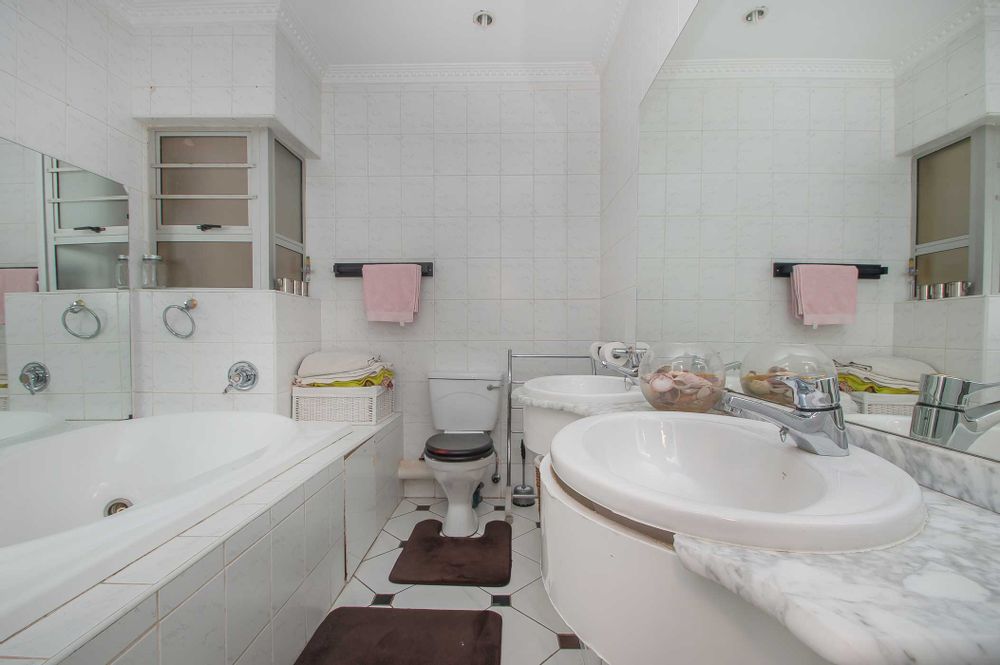 En suite with luxurious corner bath and his-hers basins