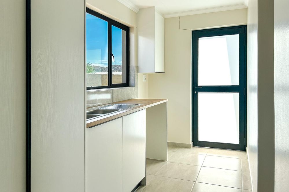 Kitchen scullery with plenty of cupboards.