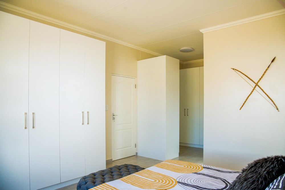 Large main bedroom with built-in cupboards, a dressing room and ensuite bathroom.